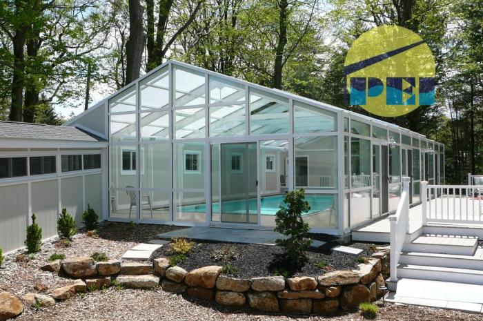 29' x 57' gabled enclosure with motorized retracting roof panels, attached walkway and equipment room.